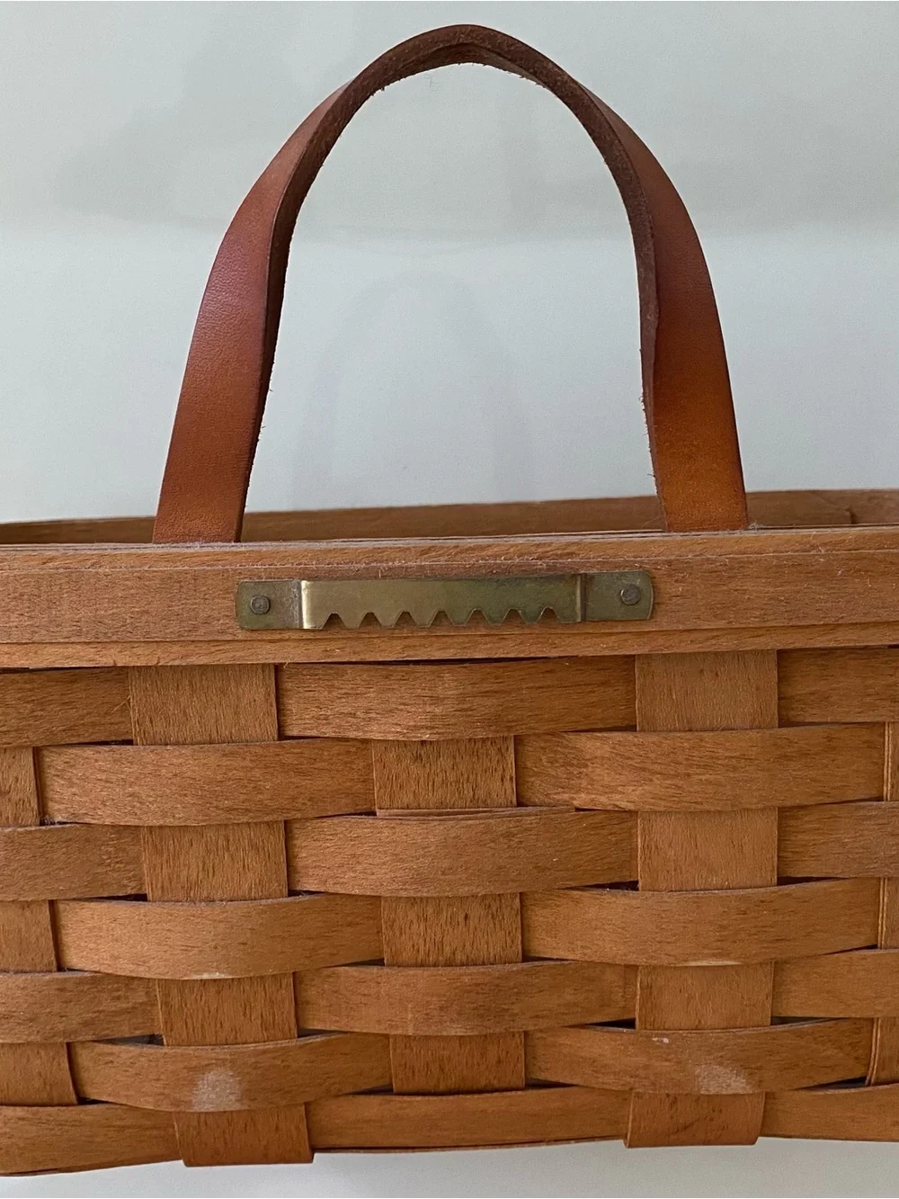 Vintage handwoven Longaberger Medium Key Basket with a leather handle.